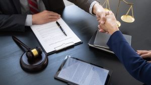 Lawyer and business owner shaking hands after an agreement on writs of garnishment.
