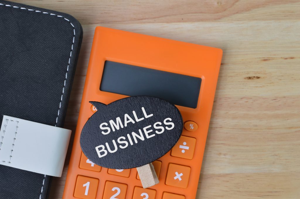 Small business sign on orange calculator