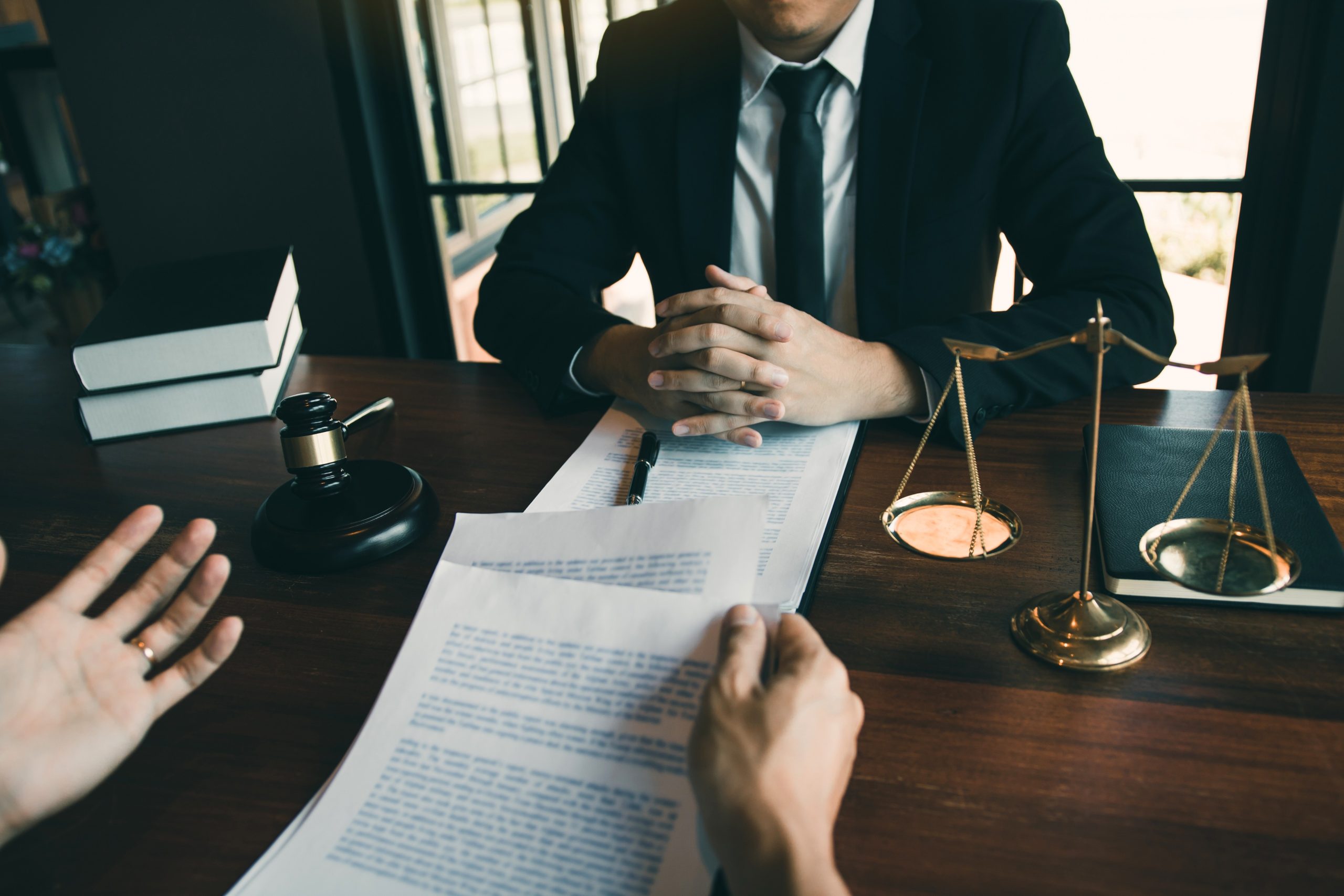 Lawyer consulting client with legal documents