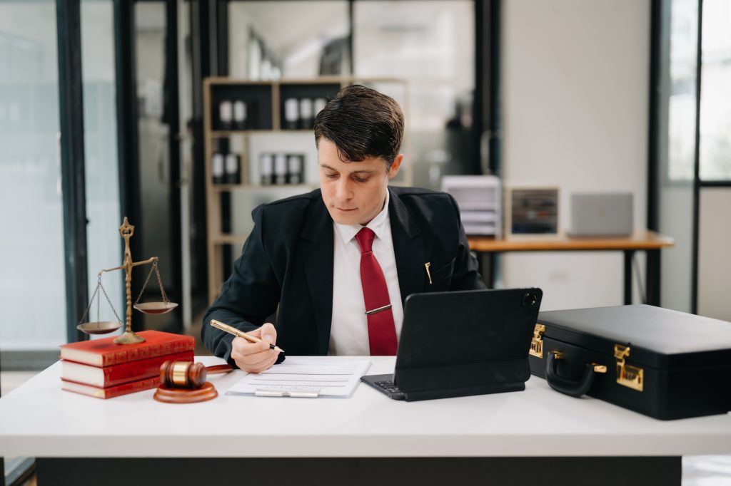 Lawyer reviewing documents at office desk